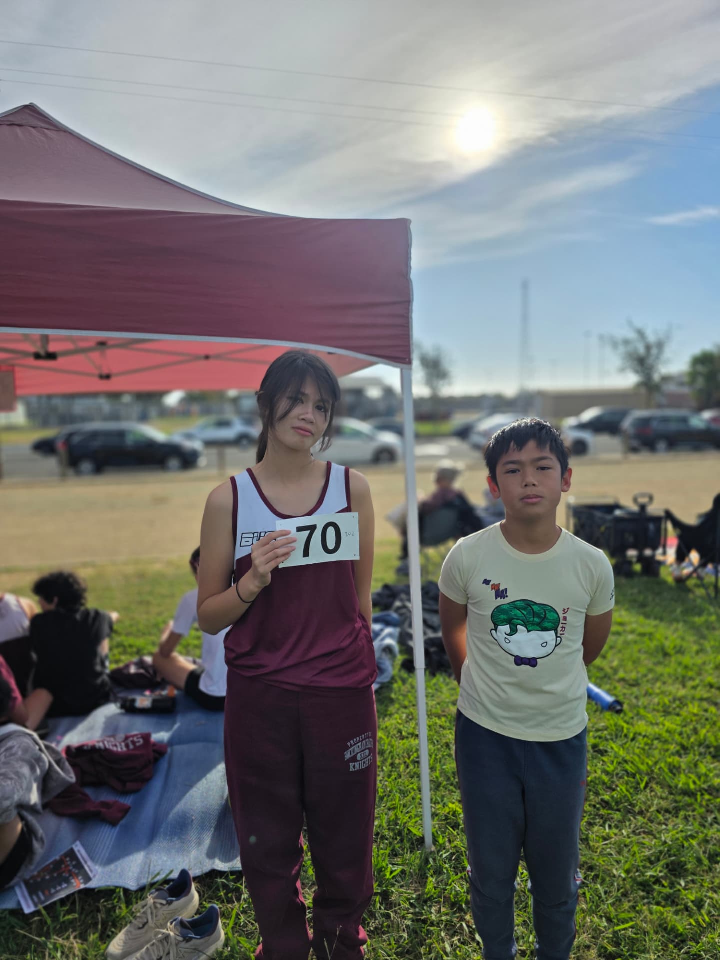 Kaitlyn holding her race bib before a meet